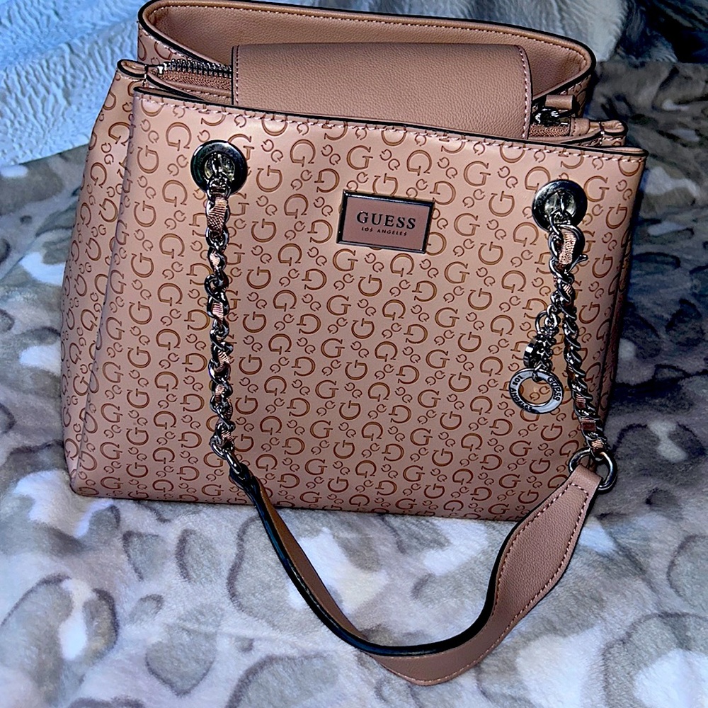 Blush pink colored Guess purse with silver hardware.